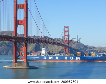 SAN FRANCISCO, USA - OCTOBER 18, 2013: A merchant ship passing under the Golden Gate suspension bridge spanning the Golden Gate strait channel between San Francisco Bay and the Pacific Ocean