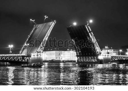 The Palace Bridge is a road traffic and foot bascule bridge spanning the Neva River in Saint Petersburg between Palace Square and Vasilievsky Island in black and white