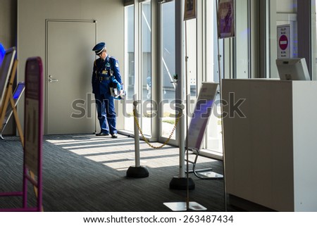 OSAKA, JAPAN - MARCH 14, 2015: Airport Police standing alone at Kansai International Airport terminal.