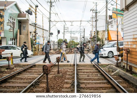 OTSU, JAPAN - JANUARY 5, 2014: People passing the railroad crossing.