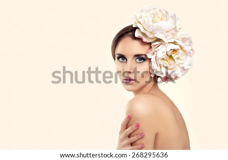 Beautiful Young Woman Model with Flower in her Hair. Perfect Fresh Skin, Skincare. Beauty Concept.