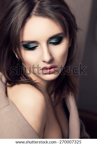 Beautiful makeup woman face looking down. Closeup portrait.