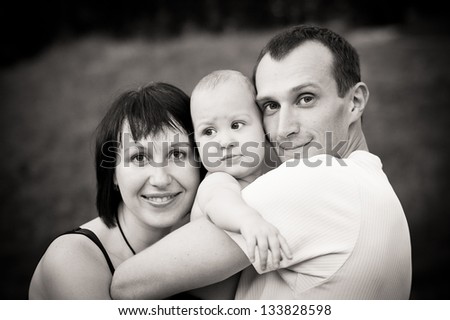 black and white portrait of happy family with baby