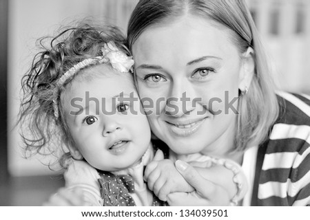 closeup black-and-white portrait of a happy mother and daughter