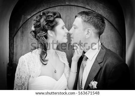 black and  white photo of faces of  men and woman in profile close up