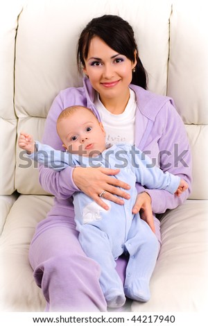 beautiful young mother holds a baby