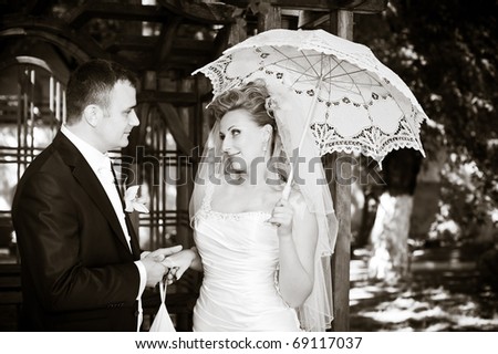 black and white photo of bride and groom with a solar umbrella