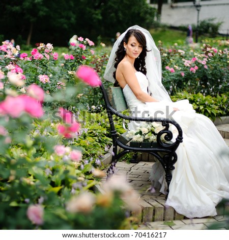 stock photo beautiful girl in a wedding dress sitting alone among the 