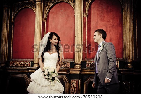 bride and groom looking at each other in a church