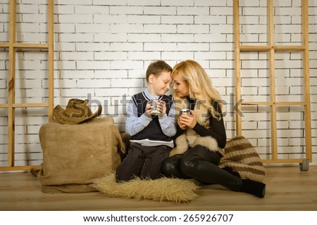 warm family portrait of mother and son in country style