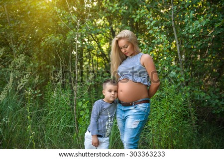 pregnant woman and her son posing together outdoor