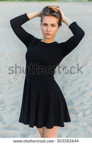 close-up portrait of a beautiful young woman in black dress