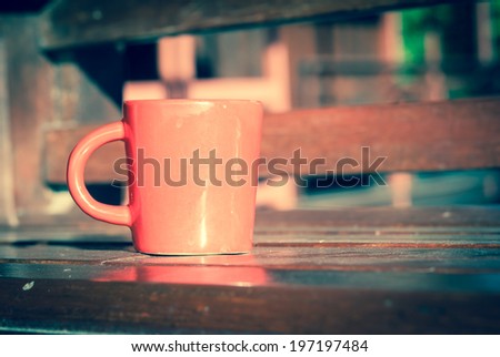 Red mug on wooden tabletop