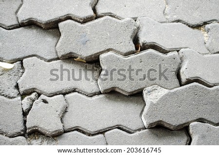 Surface of a broken cement brick pavement for textural background