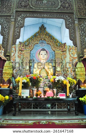 Penang, Malaysia:JULY 14, 2013: Dhammikarama Burmese  Temple Altar with Buddha and two Monks Statues. This temple is a popular tourist attraction for both locals and tourists.