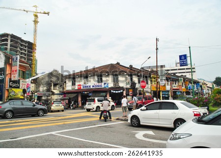 Penang, Malaysia:JULY 14, 2013: A street scape view of buildings, traffic and daily life in Georgetown, Malaysia