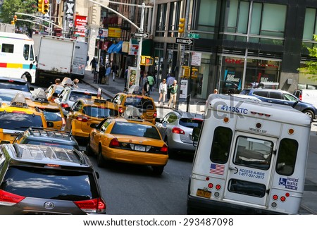 NEW YORK CITY, USA - MAY 19, 2014: Many cars in the streets of manhattan, waiting at traffic lights.
