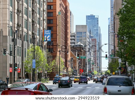 CHICAGO, USA - MAY 24, 2014: Busy street in Chicago with crossroad and traffic lights.