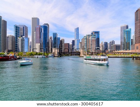 CHICAGO, USA - MAY 24, 2014: Different kinds of boats on Chicago River in front of Chicago skyline