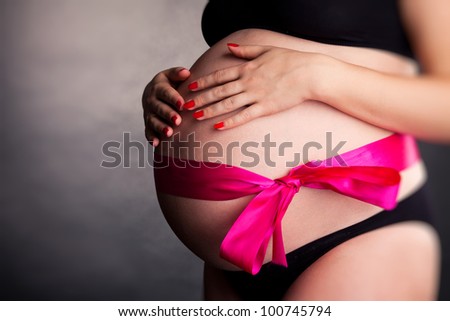 tummy of pregnant woman in studio