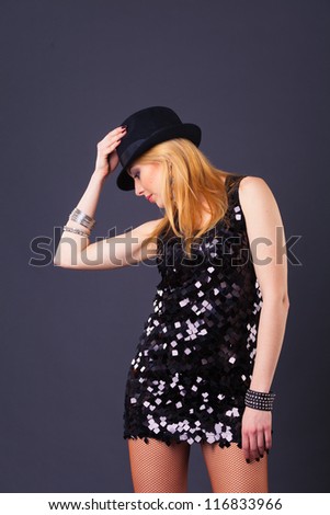 blond hair beautiful woman in black sequin dress on black background
