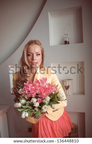 beautiful woman with tulips indoor