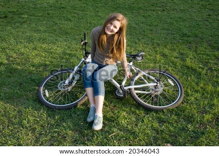 smiling girl resting after riding sitting on the bicycle