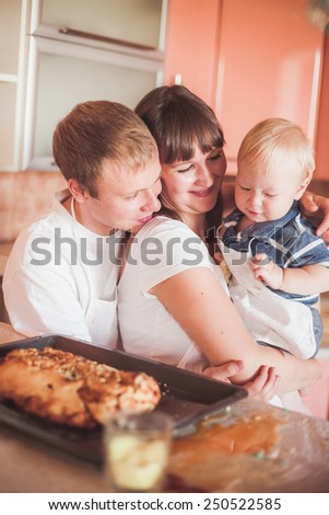 Happy family at kitchen with homemade pie