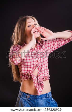 Horizontal portrait of beautiful young woman in checkered shirt. Hand gesture on mouth