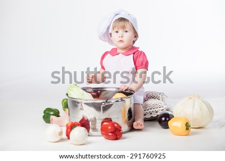 Little chef girl preparing healthy food on white background
