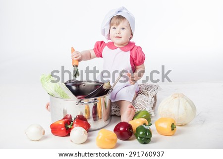 Little chef girl preparing healthy food on white background