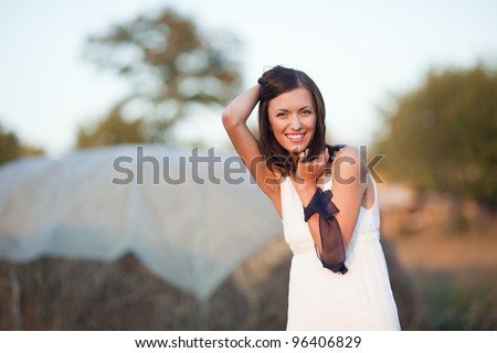 portrait of beautiful brunette young woman in countryside