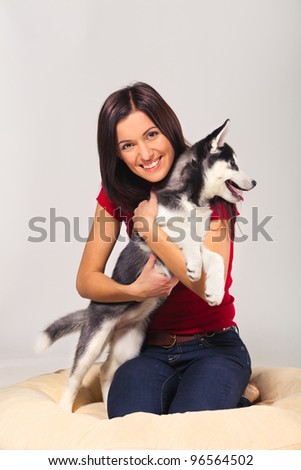 young woman with siberian husky puppy