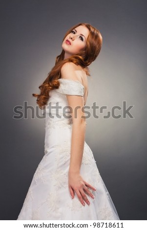 beautiful bride with curly red hair in wedding dress