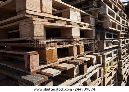 The big stack of wooden cargo pallets.