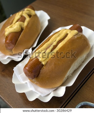 two tasty hot dog on carton plates