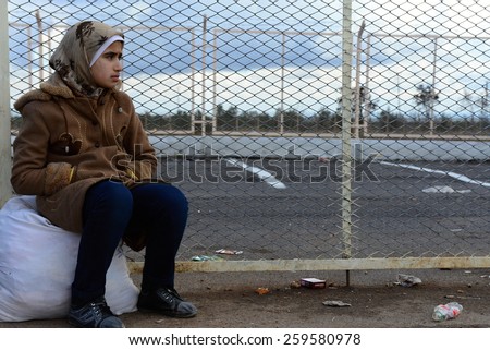Young girl crying for lost home. She escaped from Syria to Turkey and she is waiting for transport into refugee camp. \
26/2/2014 - Turkey - Kilis