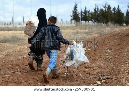 Grandmother with a boy escaping from Syria to Turkey because of long civil war. \
26/2/2014 - Turkey - Kilis