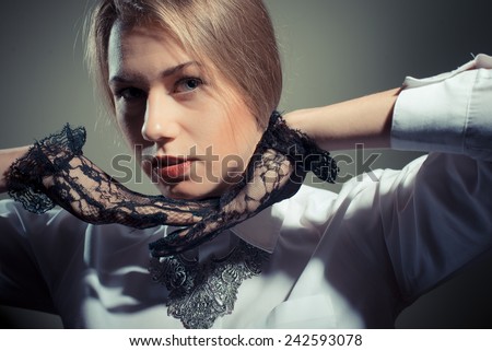 Blonde young lady in black transparent gloves