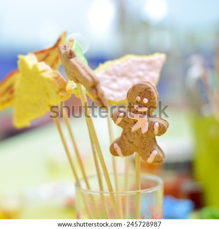 closeup on gingerbread cookies on stick in glass