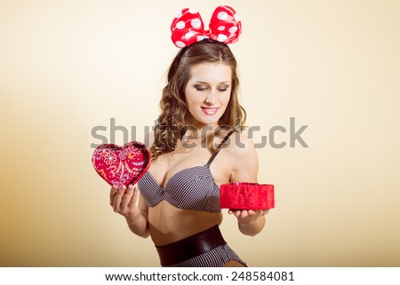 Portrait of romantic sexy young pretty lady having fun emotionally enjoying presents on light copy space background