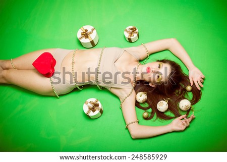 Portrait of romantic sexy young pretty woman having fun emotionally enjoying presents relaxing lying on copy space background