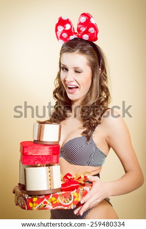 Portrait of romantic sexy young pretty lady having fun emotionally enjoying presents and blinking eye on copy space background
