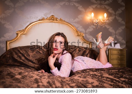 Portrait of beautiful young lady relaxing lying in bed