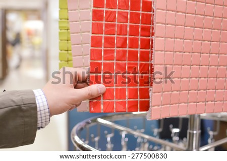 Closeup picture on hands choosing or presenting colorful samples