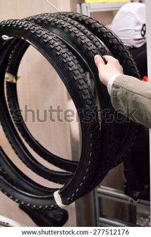Closeup picture on hand choosing or presenting cycle spare tire