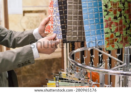 Closeup picture on hands choosing or presenting colorful samples