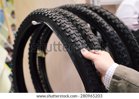 Closeup picture on hand choosing or presenting cycle spare tire