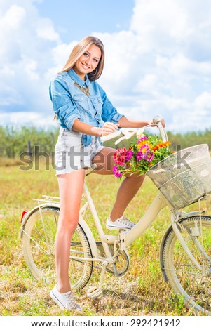Image of beautiful girl having fun relaxing with bicycle on sunny day green outdoors copy space background