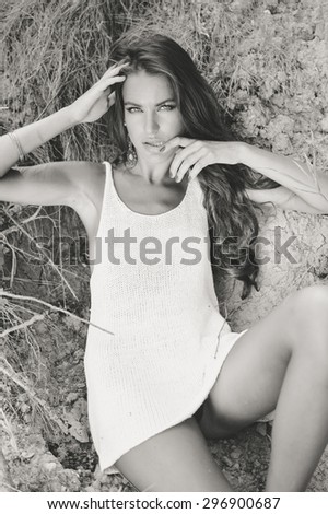 Portrait of glamour sexi young pretty lady sitting on the ground outdoors background, black and white photography
